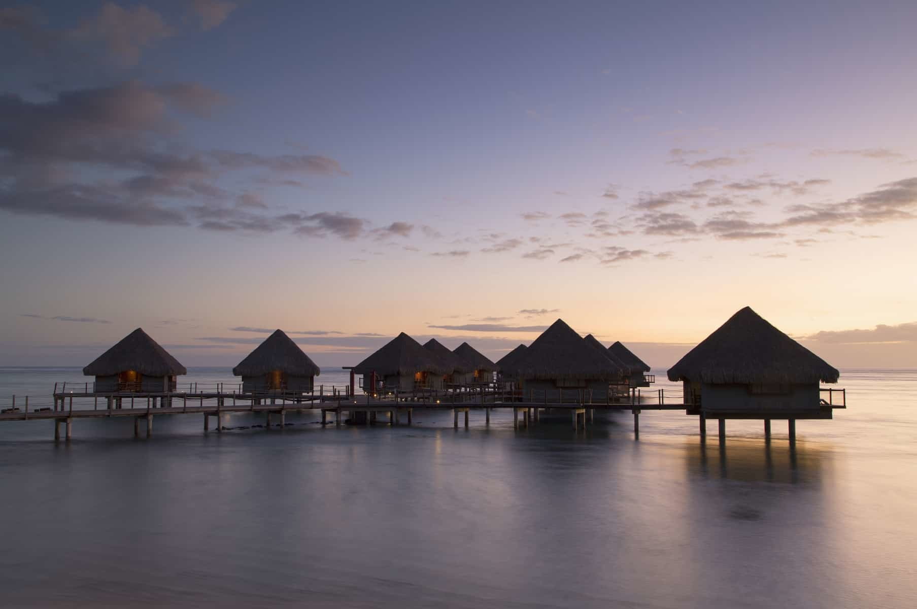 Overwater bungalows at Le Meridien Tahiti Hotel at sunset, Pape'ete, Tahiti, French Polynesia