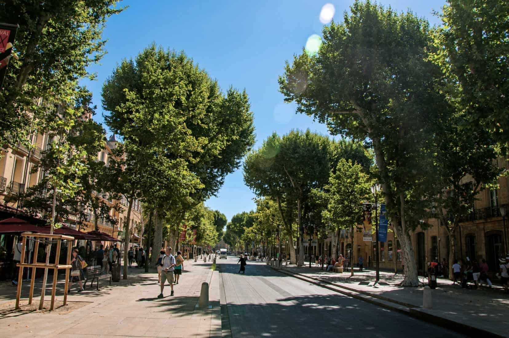 Aix-en-Provence, France - July 09, 2016. Avenue with trees and people in Aix-en-Provence, a lively town in the French countryside. In Bouches-du-Rhone department, Provence region, southeastern France