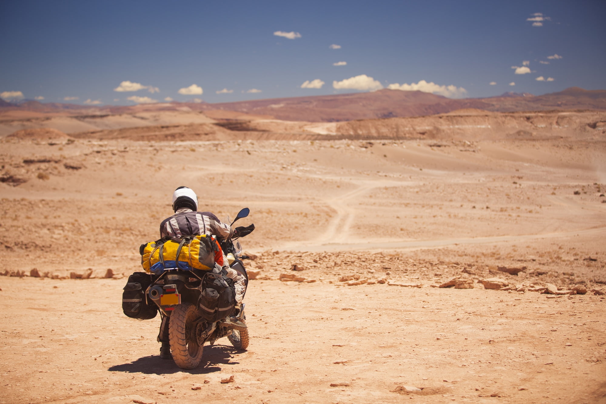 Rider travels the Atacama Desert on a motorcycle. America