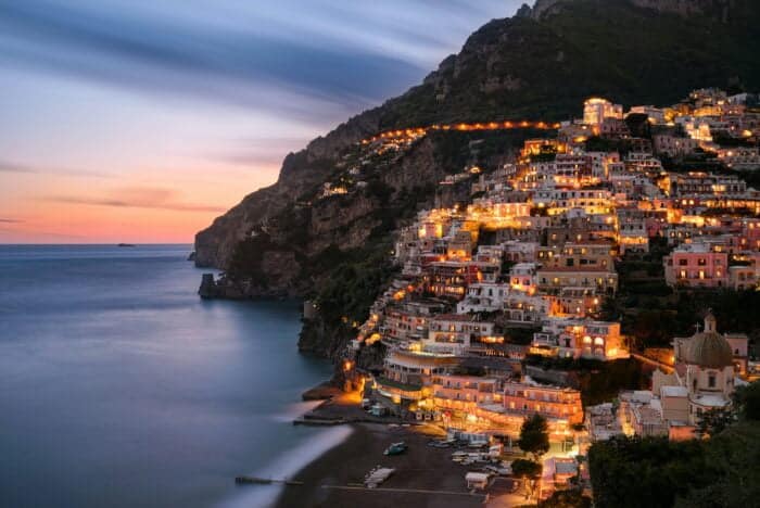 City view of Positano in the evening blue hour. Italian village on the beautiful mediterranean Amalfi coast. 