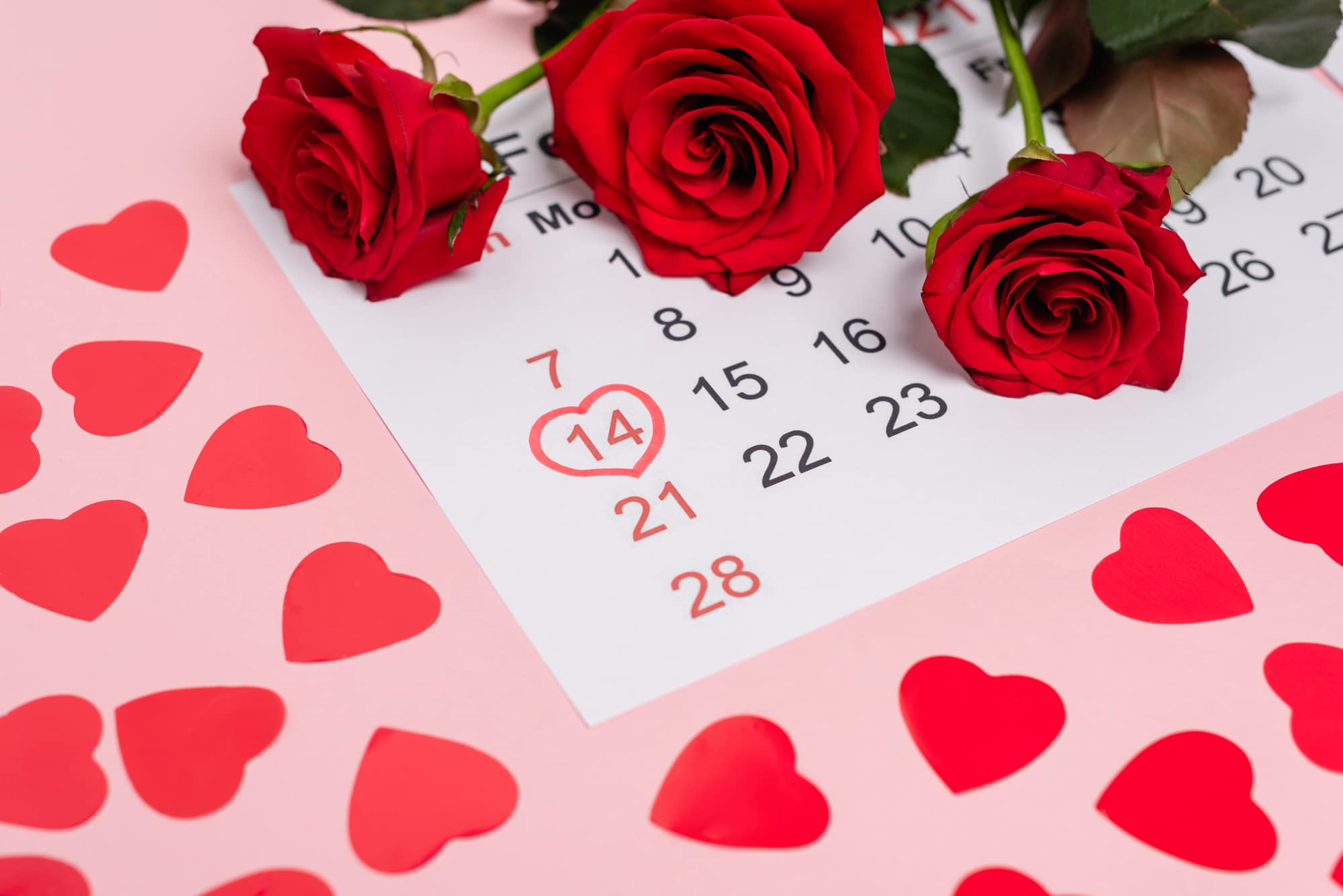 February calendar with hearts and roses on pink background